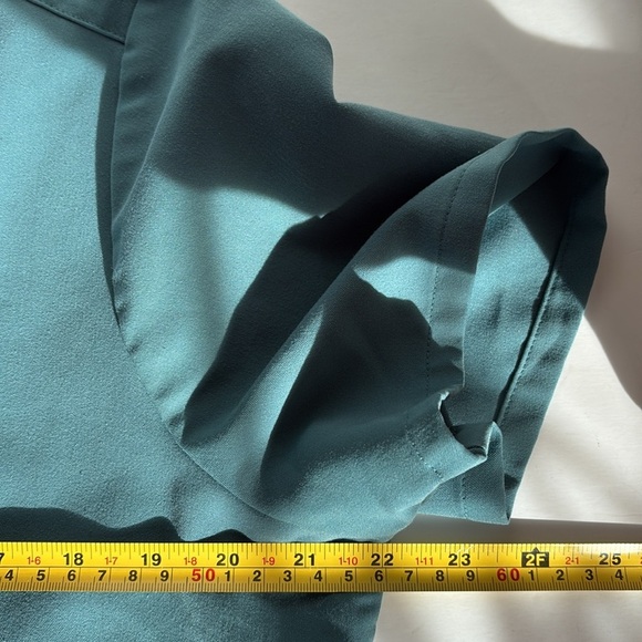 FIGS v-neck short sleeve two front pocket scrub shirt in a blue green color - Picture 13 of 16